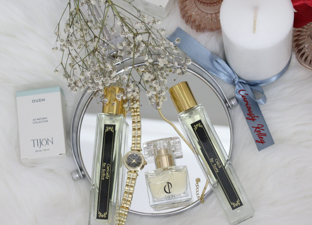 Tijon custom perfume bottles on mirror with baby's breath flowers.