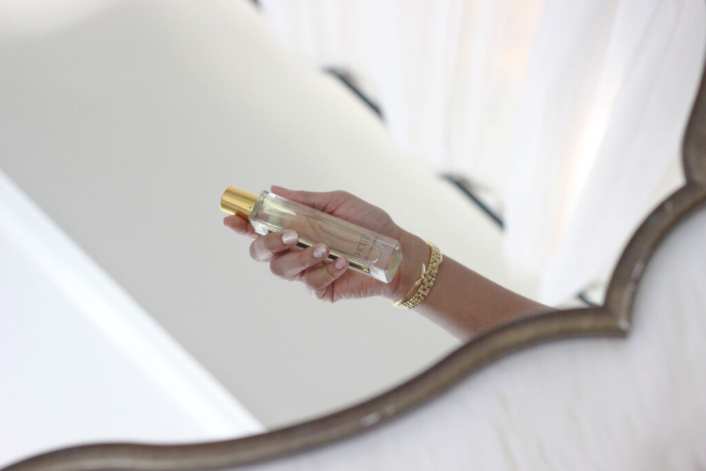 Reflection of Tijon perfume bottle in mirror