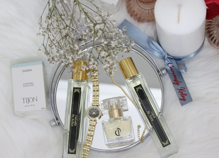 Tijon custom perfume bottles on mirror with baby's breath flowers.